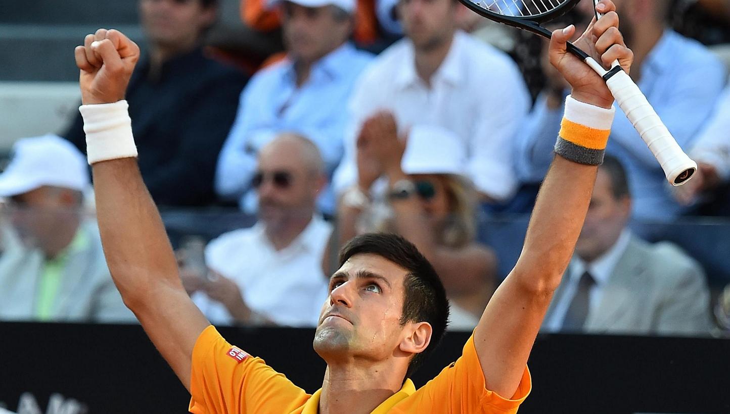 Novak Djokovic of Serbia celebrates after beating Swiss Roger Federer in their final match for the Italian Open tennis tournament at the Foro Italico in Rome on Sunday. -- PHOTO: EPA