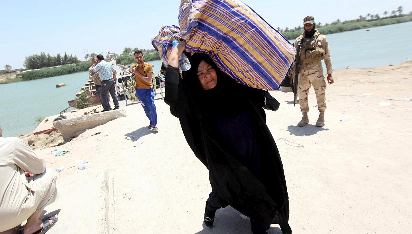 Displaced Sunni people fleeing the violence in the city of Ramadi arrive at the outskirts of Baghdad on Saturday. -- PHOTO: REUTERS