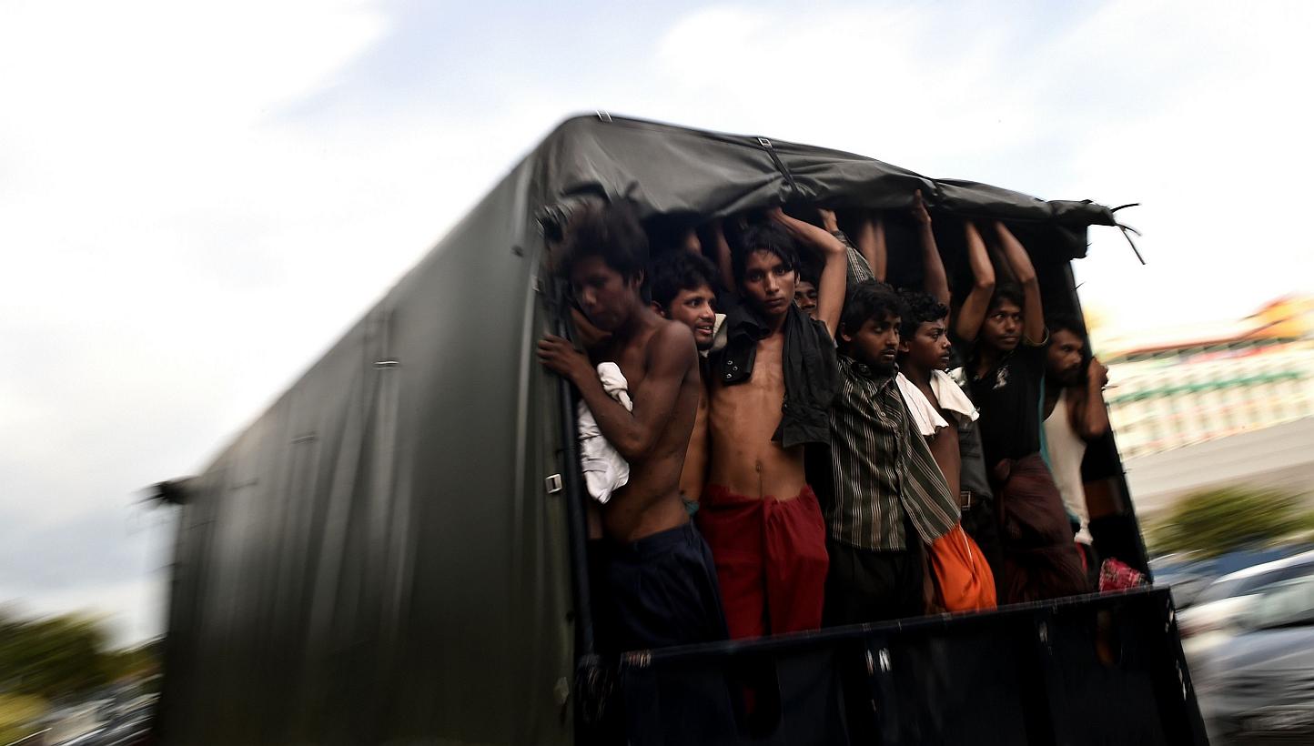 Bangladeshi migrants standing in a moving police van at the police headquarters in Langkawi on May 11, 2015. -- PHOTO: AFP 