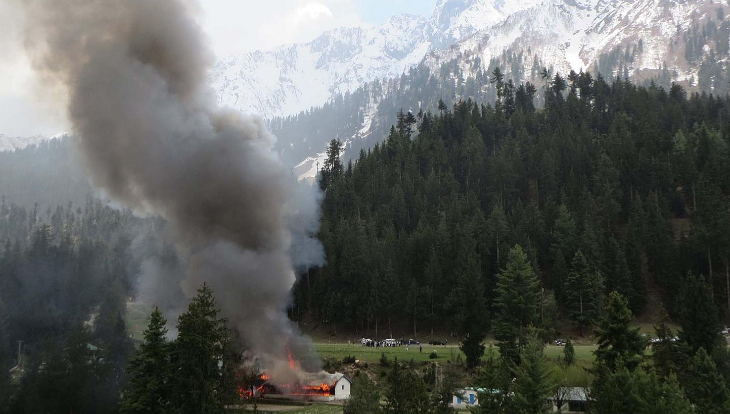 Flame and smoke rising from the site where a Pakistani military helicopter crashed in the northern area of Gilgit on May 8, 2015. -- PHOTO: AFP