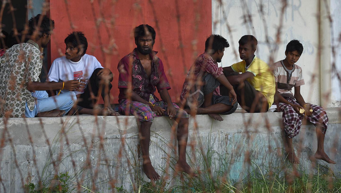 Rescued migrants from Bangladesh rest at the confinement area in the fishing port of Kuala Langsa in Aceh province on May 17, 2015. -- PHOTO: AFP&nbsp;