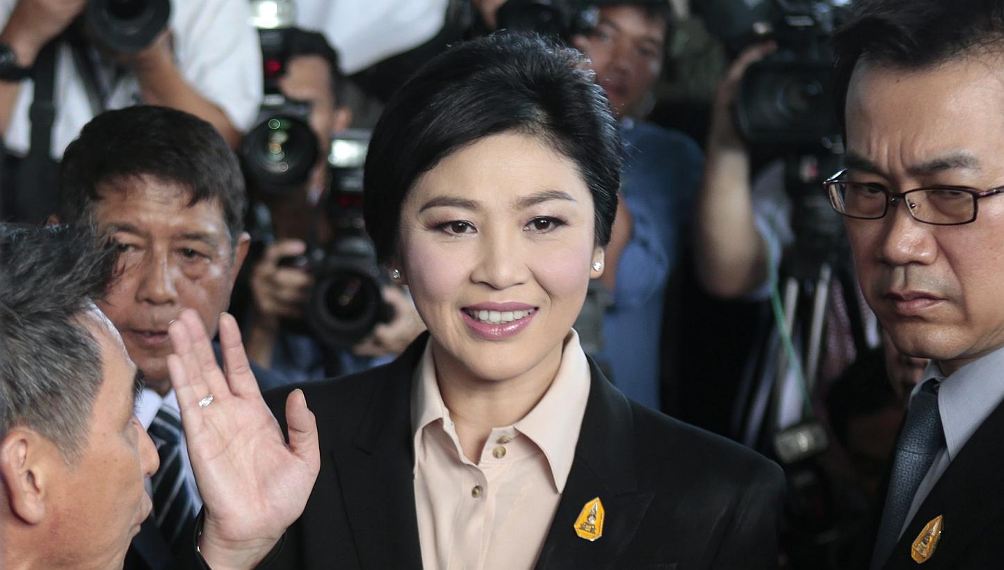 Thailand's ousted prime minister Yingluck Shinawatra (centre) greeting well-wishers and supporters as she arrives at the Supreme Court to face charges of corruption over a rice subsidy plan, in Bangkok, on May 19, 2015. -- PHOTO: EPA 