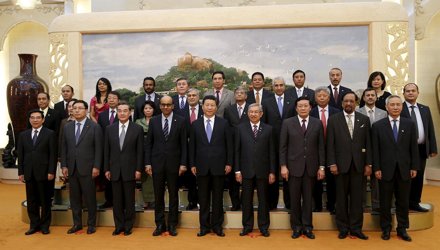 China's President Xi Jinping (centre) posing for photos with guests at the Asian Infrastructure Investment Bank launch ceremony at the Great Hall of the People in Beijing, on Oct 24, 2014. -- PHOTO: REUTERS