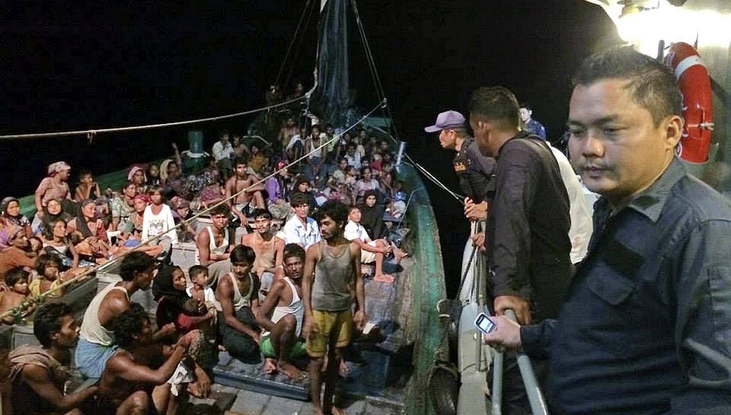 A Royal Thai Navy handout photo made available on 19 May 2015 shows some 450 ethnic Rohingya migrants believed to be from Myanmar and Bangladesh on a boat, which was abandoned by it's captain and crew, being inspected by Thai navy officers in the And