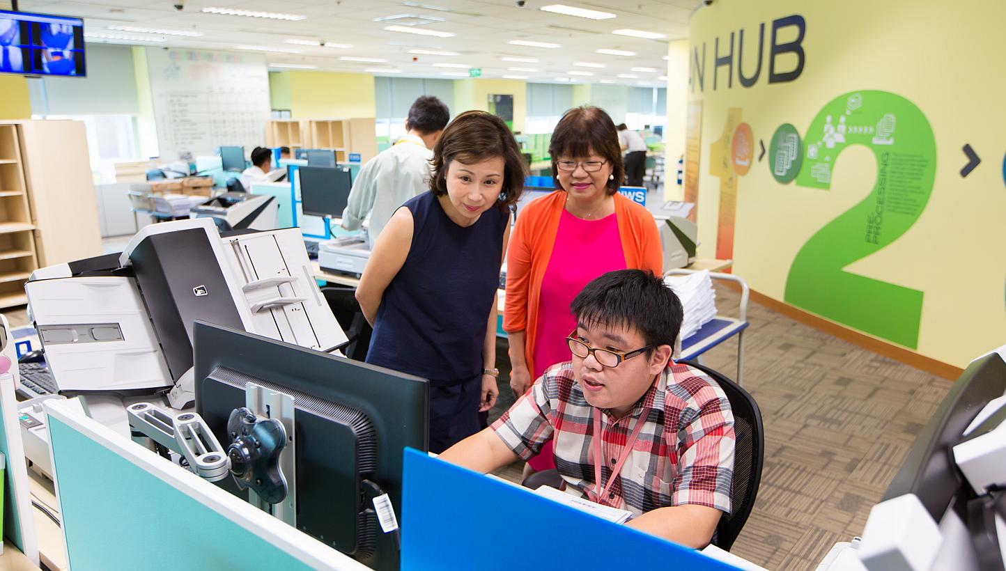 (From left) UOB Group head of technology and operations Susan Hwee, Autism Resource Centre president Denise Phua and UOB Scan Hub clerical assistant Feng Zhi Hua. People with autism account for about one-third of the 53 employees at the Scan Hub, whe