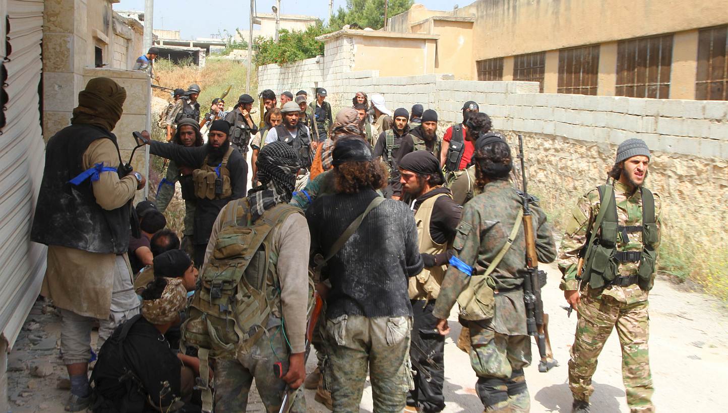 Rebel fighters gather in Mastouma village, after they said they had advanced on the area, in Idlib city, on May 19, 2015. A rebel coalition including Al-Qaeda's local affiliate seized the Syrian regime's largest remaining military base in Idlib