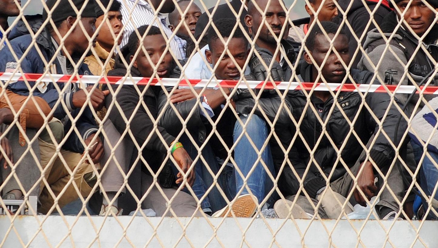 Migrants wait to disembark from military ship "Bettica" following a rescue operation at sea on May 5 in the port of Salerno in southern Italy.-- PHOTO: AFP&nbsp;