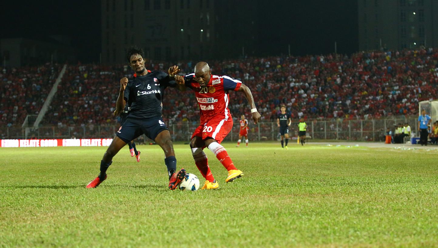 LionsXII defender Madhu Mohana (left) and Kelantan striker Emmanuel Kenmogne. The LionsXII will face Kelantan in what will be a highly-anticipated Malaysian FA Cup final at the Bukit Jalil Stadium in Kuala Lumpur this Saturday, and a state public hol