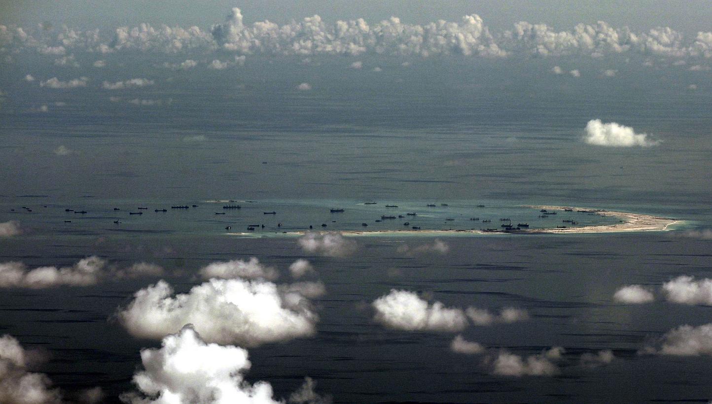 This aerial photograph taken from a military aircraft shows alleged ongoing reclamation by China on Mischief Reef in the Spratly group of islands in the South China Sea, west of Palawan, on May 11, 2015. -- PHOTO: AFP 