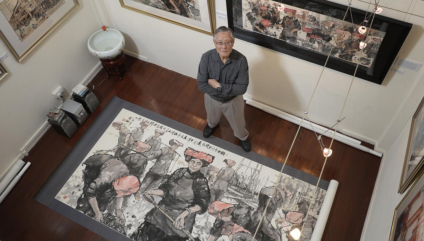Watercolourist Tong Chin Sye with Toiling For Our Loved Ones, his largest work at the exhibition.