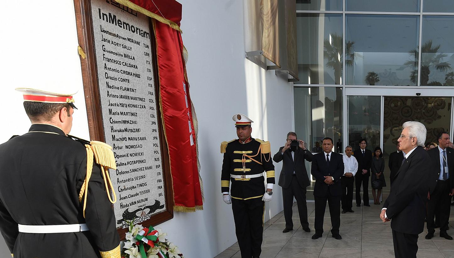 Italian President Sergio Mattarella (right) lays a wreath at a monument displaying the names of those killed in the Bardo Museum attack, during his visit to Tunis on May 18, 2015. Italian police have arrested a Moroccan man suspected of taking part i