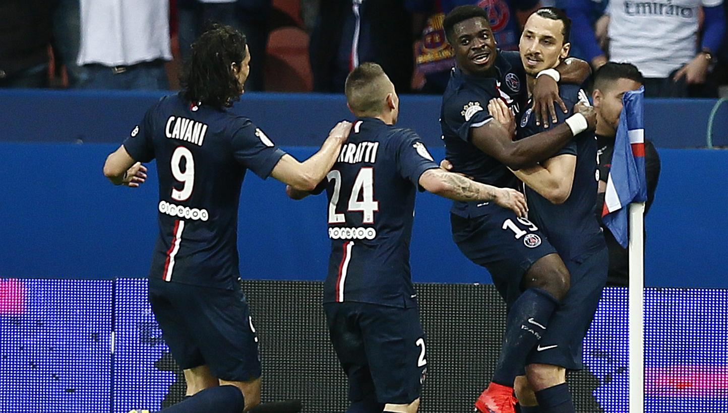 Paris St Germain's Zlatan Ibrahimovic (right) celebrates with Paris St Germain's Serge Aurier (second-right) after scoring the 2-0 goal during the French Ligue 1 soccer match between Paris Saint-Germain (PSG) and EA Guingamp at the Parc des Princes s