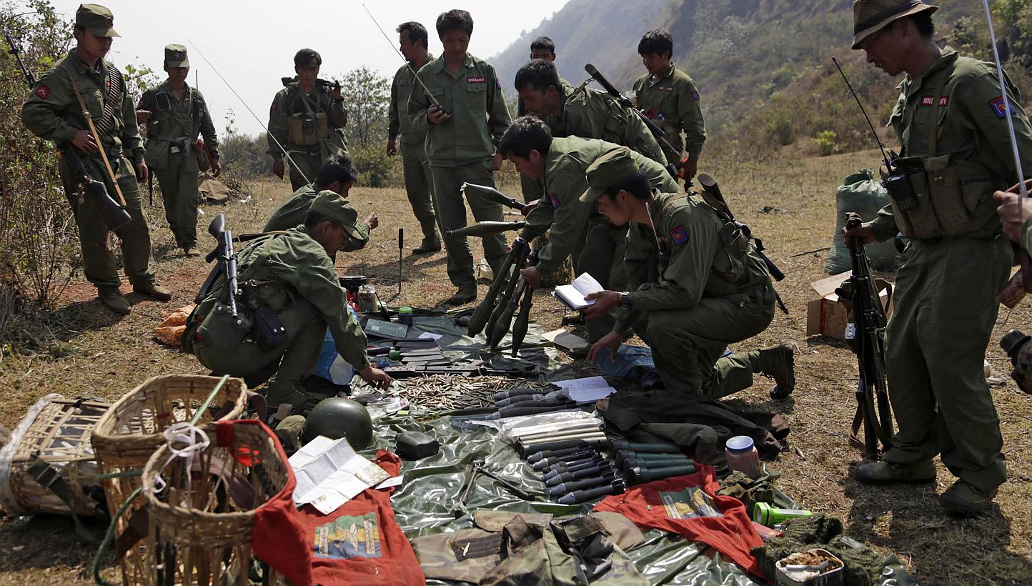 Rebel soldiers of the Myanmar National Democratic Alliance Army (MNDAA) examine weapons and ammunition at a military base in Kokang region on March 10, 2015.&nbsp;China on Wednesday said it had lodged a protest with Myanmar after shelling injured fiv