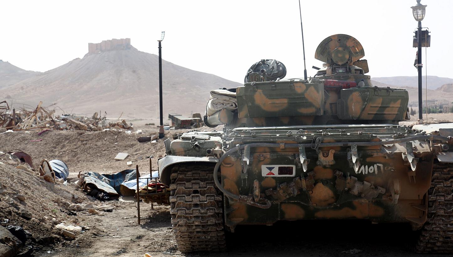A Syrian armoured tank take up position during fightings against Islamic State in Iraq and Syria (ISIS) militants in the ancient oasis city of Palmyra, about 215km north-east of Damascus, Syria, on May 19, 2015.&nbsp;ISIS fighters seized around a thi