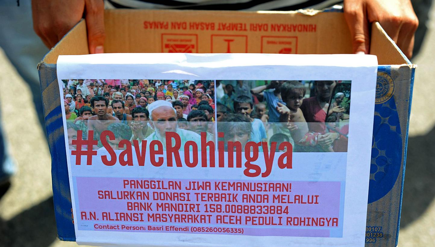 An Acehnese student holds a donation box for charity during a rally in support of Rohingya migrants in Banda Aceh on May 19, 2015. Malaysia's foreign minister was to host his Indonesian and Thai counterparts on Wednesday for urgent talks on South-eas