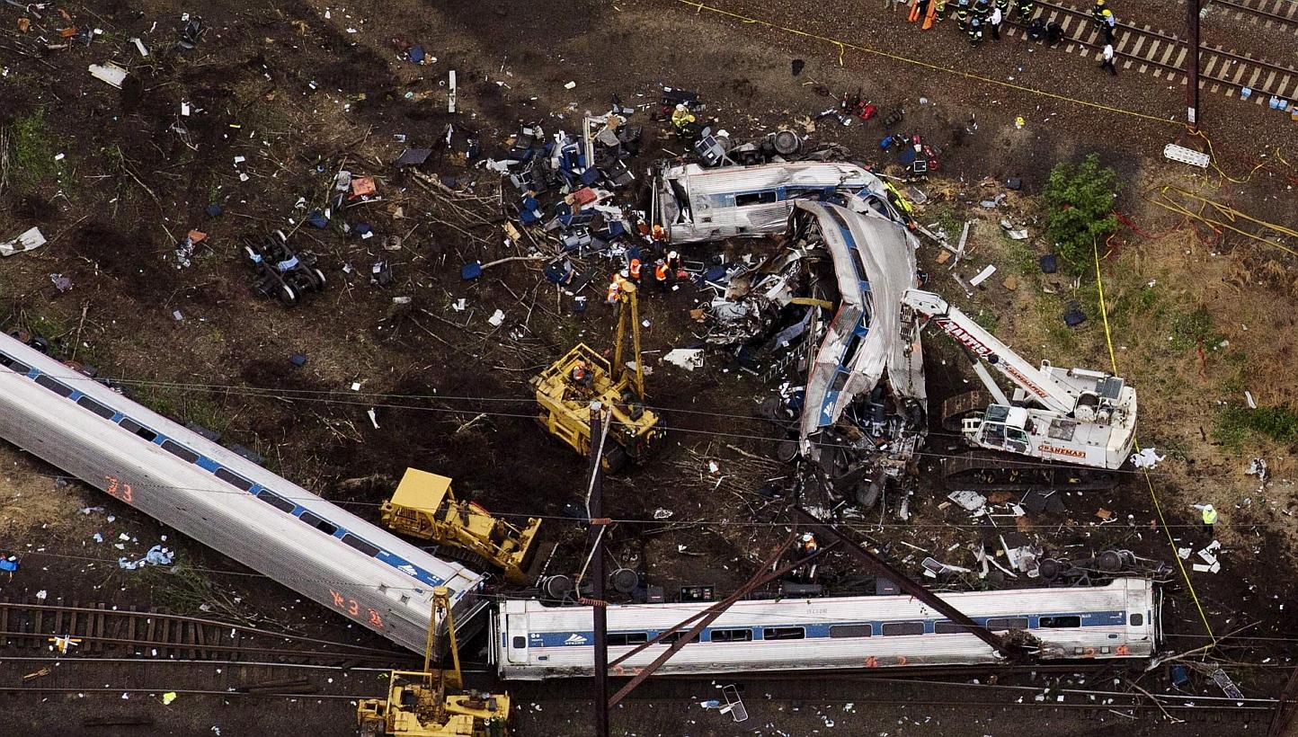 Emergency workers look through the remains of a derailed Amtrak train in Philadelphia, Pennsylvania, in this file photo taken May 13. -- PHOTO: REUTERS