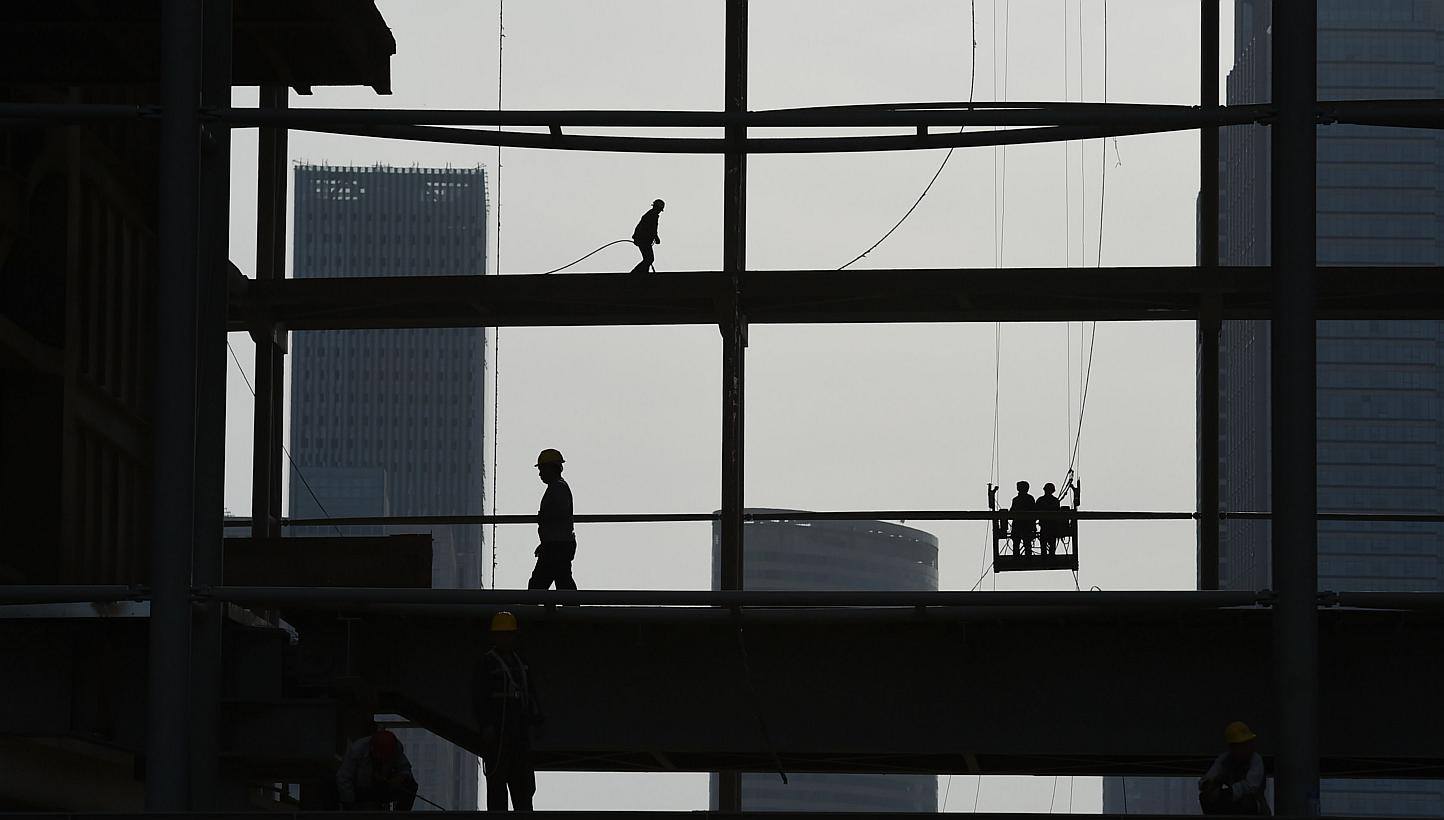 Workers on a construction site in Tianjin, northern China, on May 13, 2015. Chinese Premier Li Keqiang said he was confident that China has the ability to meet its 2015 economic growth target of around 7 per cent, the official news agency Xinhua repo