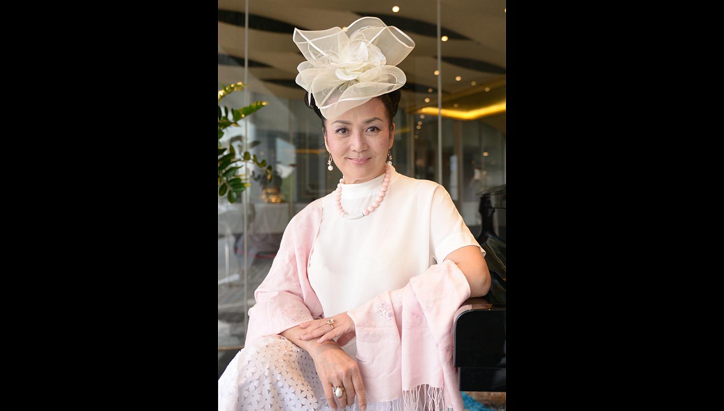 “I chose this because I wanted to feel like a bride. I’m destined to be with movies so there’s no need to think about searching for another companion.” — Fung Bo Bo, on her white cocktail dress and flower headpiece -- ST PHOTO: DANIEL
