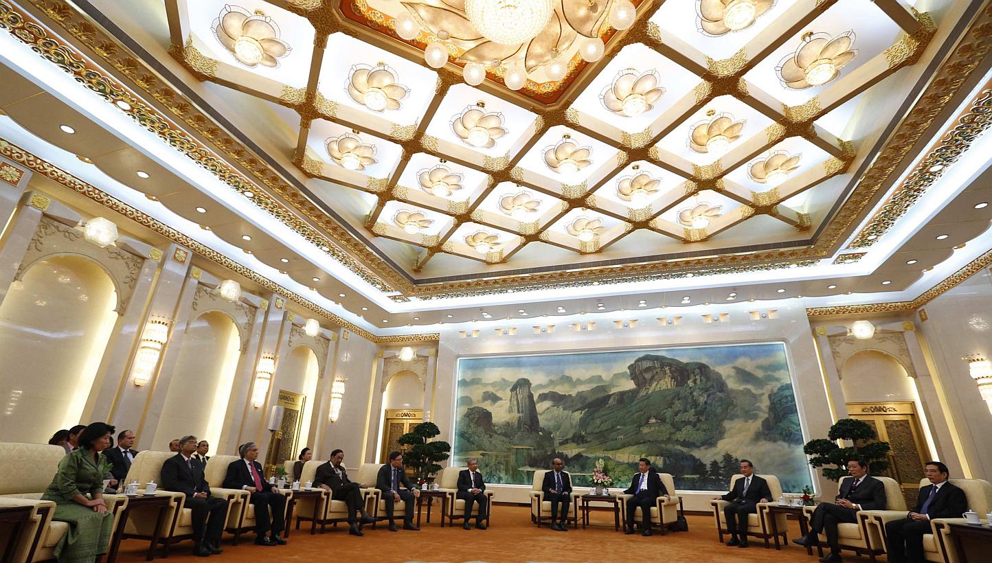 China's President Xi Jinping (fourth from right) meeting with the guests at the Asian Infrastructure Investment Bank launch ceremony at the Great Hall of the People in Beijing in Oct 24, 2014. - PHOTO: REUTERS