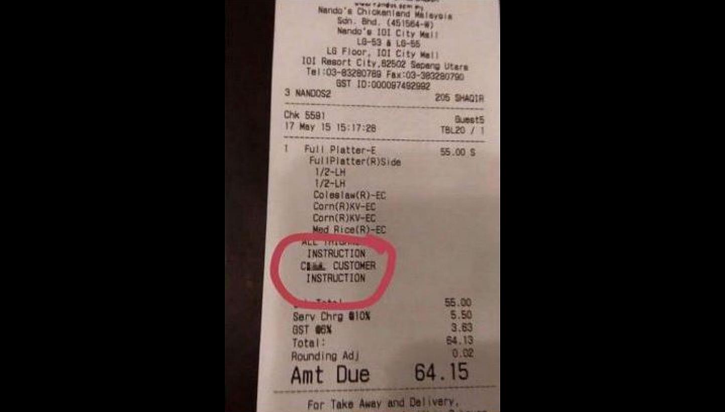 The photo of the Nando's recipt which contained the expletive. One of the restaurant chain's employees was sacked after it was shared widely on social media. -- PHOTO: VIA THE STAR/ASIA NEWS NETWORK