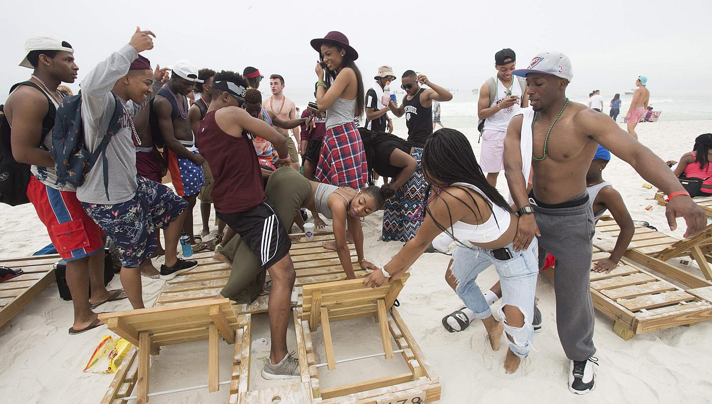 People gather to twerk during spring break festivities in Panama City Beach, Florida on March 12, 2015. "Twerking", "hashtag" and "facetime" are among 6,500 brash new entries in the Scrabble dictionary that reflect the Internet age but have left trad