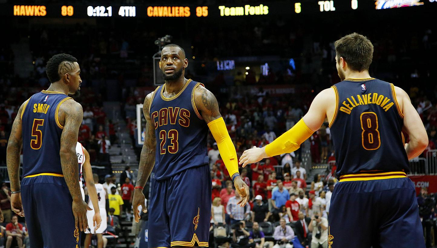 LeBron James (centre), J.R. Smith (left) and Matthew Dellavedova (right) of the Cleveland Cavaliers react after Iman Shumpert drew a foul in the second half against the Atlanta Hawks during Game One of the Eastern Conference Finals of the 2015 NBA Pl