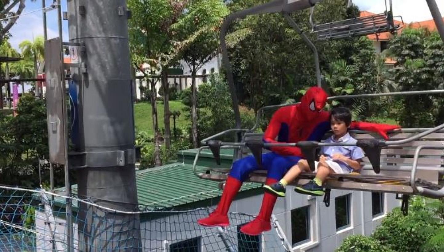 Mr Suhaimi Latiff had to train for six months as the Spider-Man costume is skin-tight, and the full face mask is not easy to breathe through. "Spider-Man" and Zeyrian even went on a trip to Sentosa. -- SCREEN GRAB FROM VIDEO / JULIA JEMANGIN 