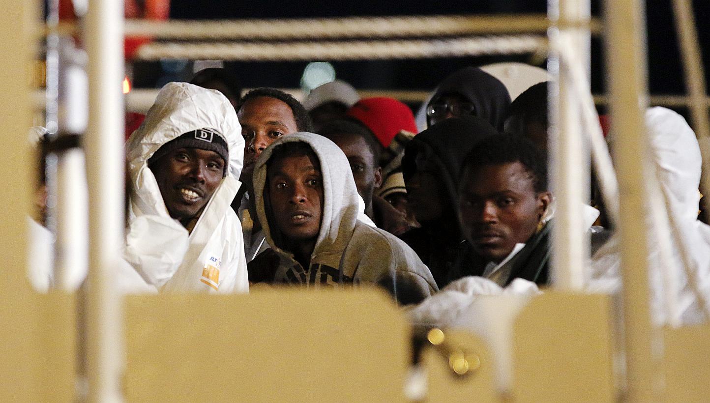 Migrants wait aboard a navy ship before being disembarked in the Sicilian harbour of Augusta on March 4, 2015.&nbsp;The arrest in Italy of a terror suspect posing as a boat migrant has fuelled nightmare scenarios of Islamic militant infiltration of E