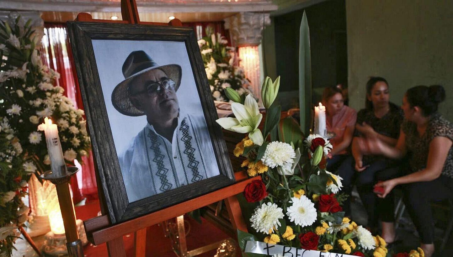 Relatives keeping vigil over the candidate for Yurecuaro mayor Enrique Hernandez (in the portrait) during his funeral chapel at his home in Yurecuaro, in the state of Michoacan, Mexico, on May 15, 2015. A town police chief in Mexico is allegedly