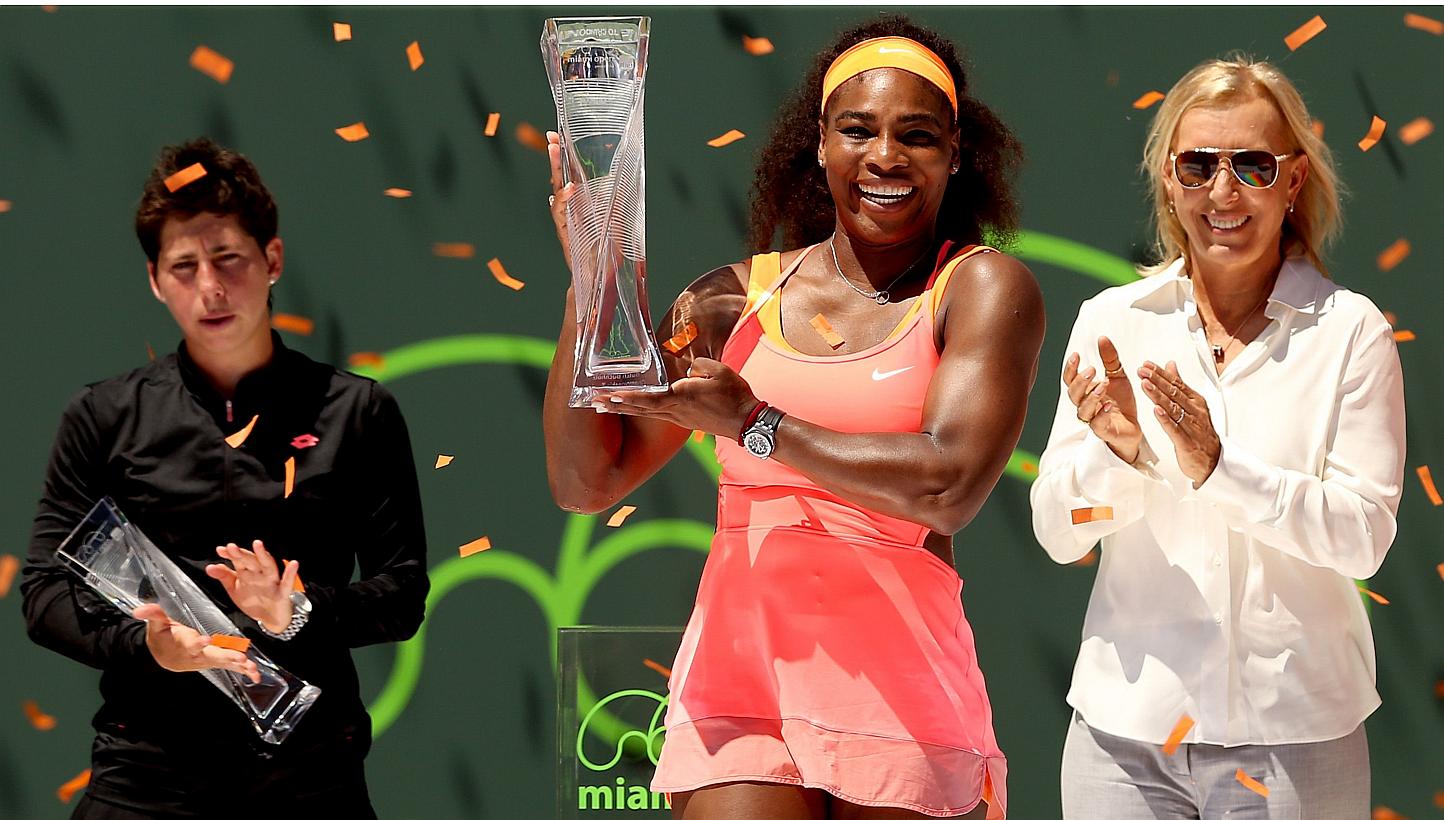 Flanked by Carla Suarez Navarro of Spain and Martina Navratilova, Serena Williams poses with the Butch Buchholz Trophy after defeating Navarro during the final on day 13 of the Miami Open Presented by Itau at Crandon Park Tennis Center on April 4, 20