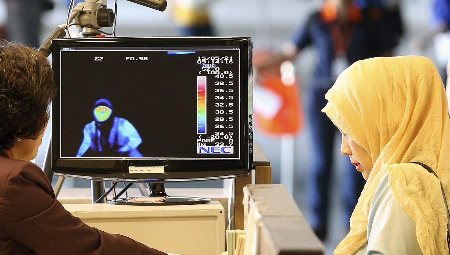 Arriving passengers from the Middle East pass by a thermal camera at Incheon airport, west of Seoul, South Korea, on May 21, 2015.&nbsp;South Korean health officials confirmed the country's third case of Middle East Respiratory Syndrome (Mers) on Thu