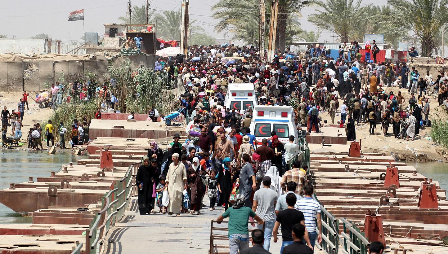 Iraqi residents from the city of Ramadi, who fled their homes as Islamic State militants tightened their siege on the last government positions in the capital of Anbar province, wait to cross Bzeibez bridge, on the southwestern frontier of Baghdad, o