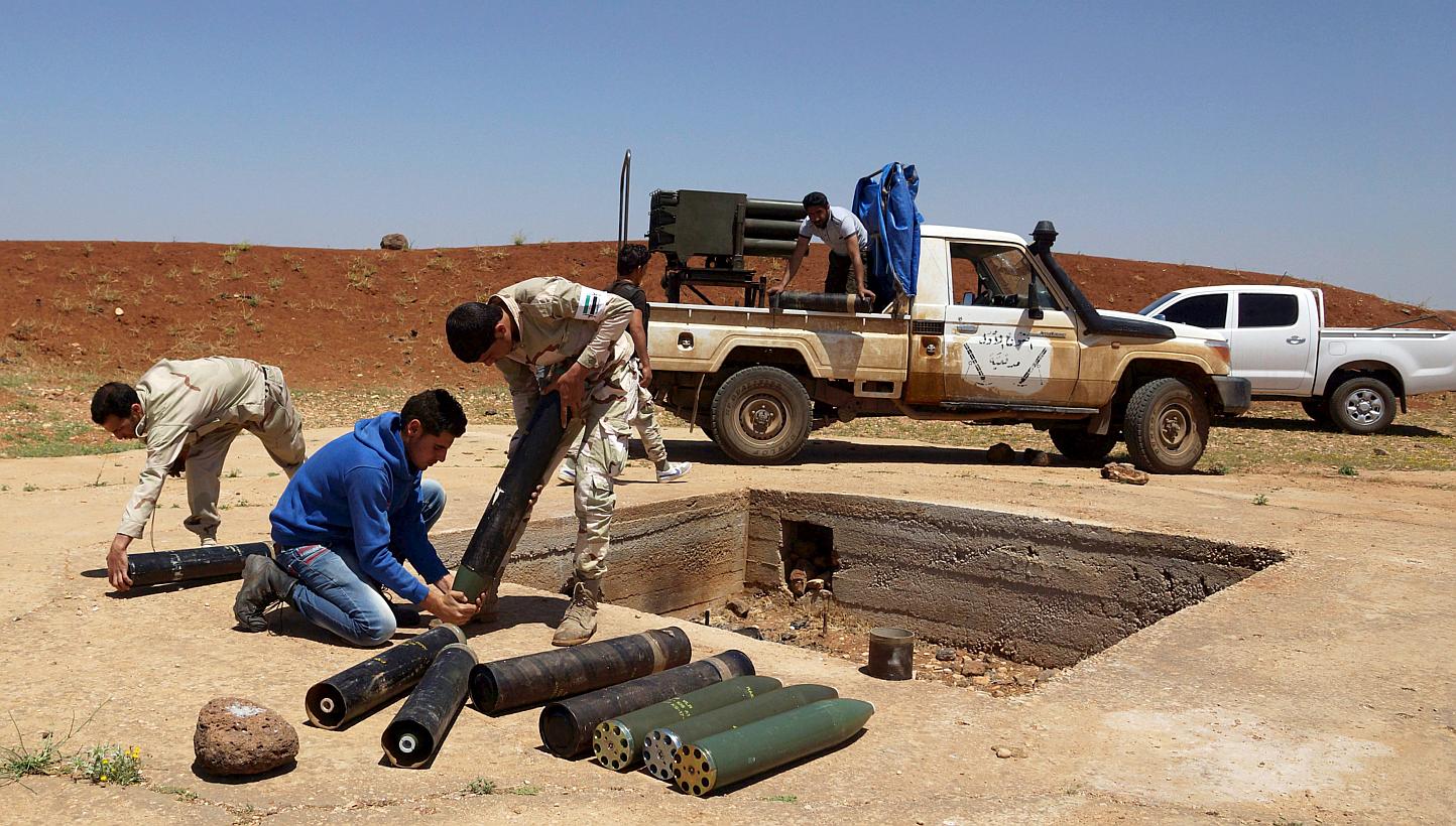 Free Syrian Army fighters prepare shells prior to firing towards forces loyal to Syria's President Bashar al-Assad in Izra'a in the Deraa countryside on May 21, 2015. At least 40 rebels were killed as a regime air strike on their base in the northern