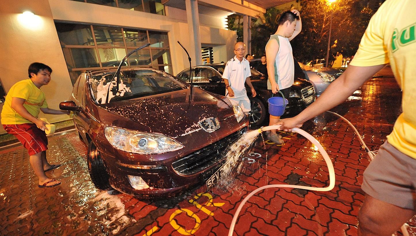 Students taking part in a fund-raising car wash as part of the Victoria Challenge in 2011. -- PHOTO: ST FILE