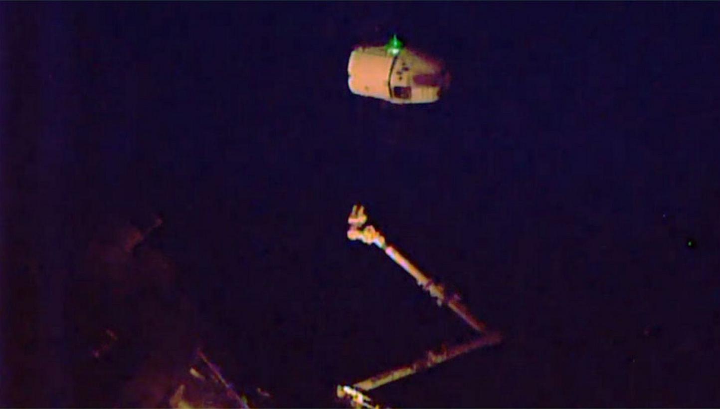 A May 21, 2015 Nasa TV image shows the SpaceX Dragon released and beginning its departure while the International Space station is in orbital night. -- PHOTO: AFP