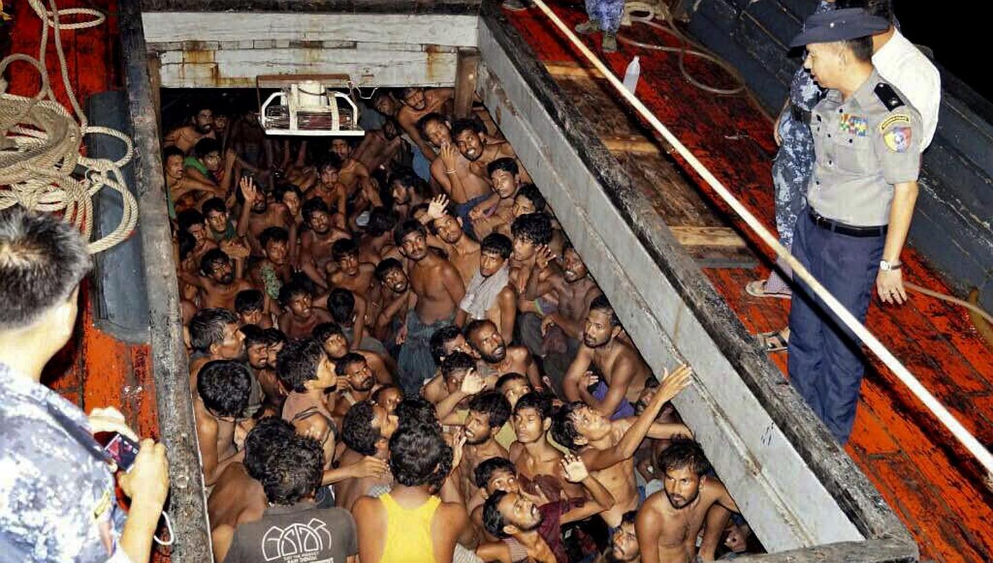 A photo provided by the Myanmar Information Ministry shows Myanmar police officers on a fishing boat filled with migrants in Rakhine on May 22, 2015. Indonesia has told Australia that most of the migrants stranded at sea in South-east Asia are illega