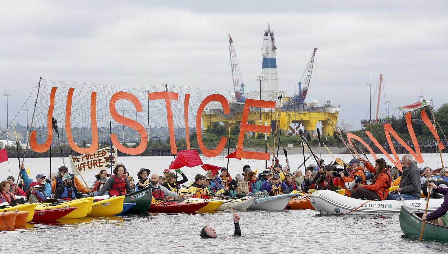 Environmental activists who fanned out in small boats across a Seattle bay over the weekend in a protest over Royal Dutch Shell's plans for Arctic oil exploration in the have damaged "precious habitat" on the sea floor, a state official said on Frida