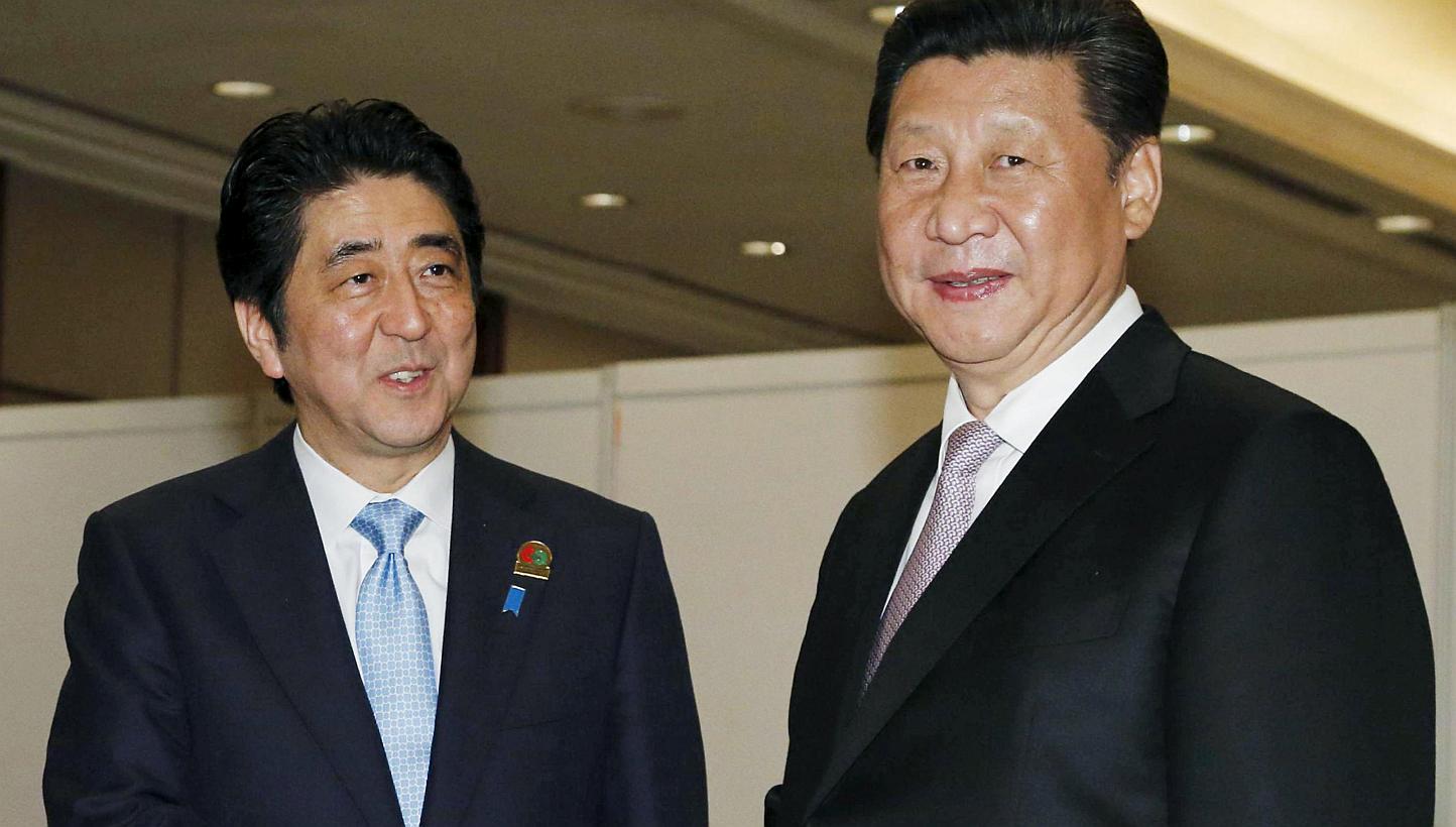 China's President Xi Jinping (right) meeting Japan's Prime Minister Shinzo Abe at&nbsp;a conference in Jakarta on April 22, 2015. -- PHOTOS: REUTERS