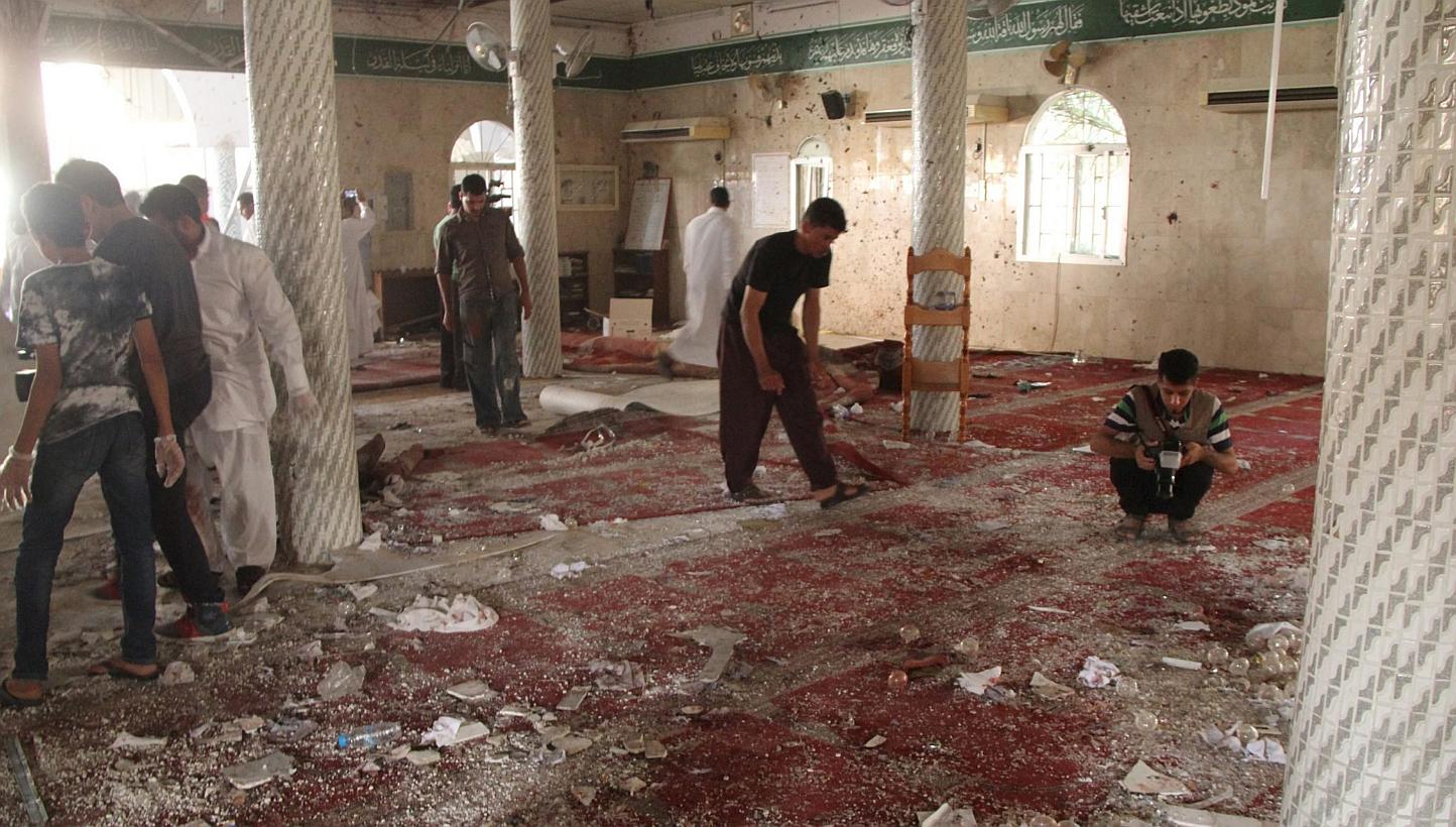 People examine the debris after a suicide bomb attack at the Imam Ali mosque in the village of al-Qadeeh in the eastern province of Gatif, Saudi Arabia on May 22, 2015. -- PHOTO: REUTERS