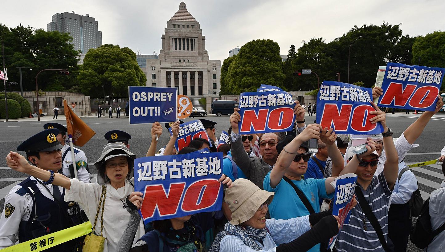 People stage a rally in front of the parliament (centre, top) in Tokyo on May 24, 2015 to protest against a controversial US airbase on Okinawa island, in southern Japan.&nbsp;-- PHOTO: AFP&nbsp;