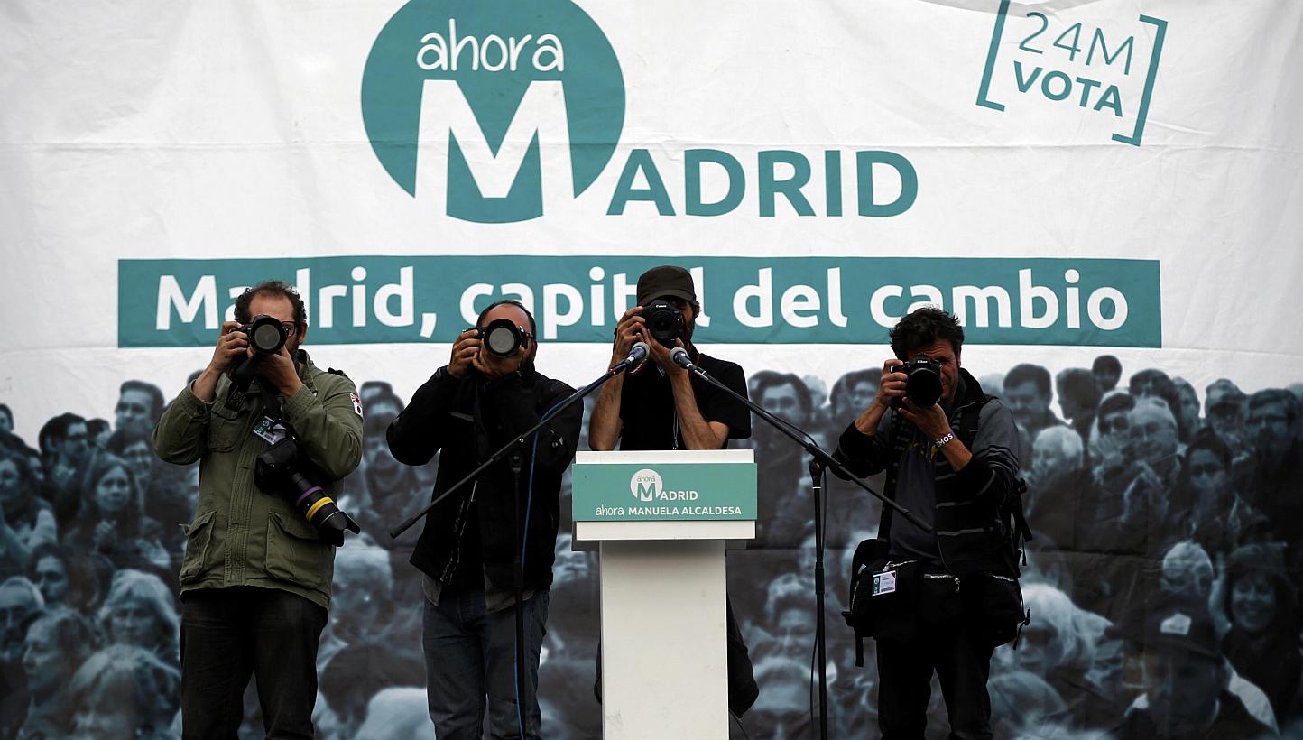 News photographers take pictures from stage at Ahora Madrid's (Now Madrid) meeting area after the regional and municipal elections in Madrid, Spain, on May 24, 2015. -- PHOTO: REUTERS