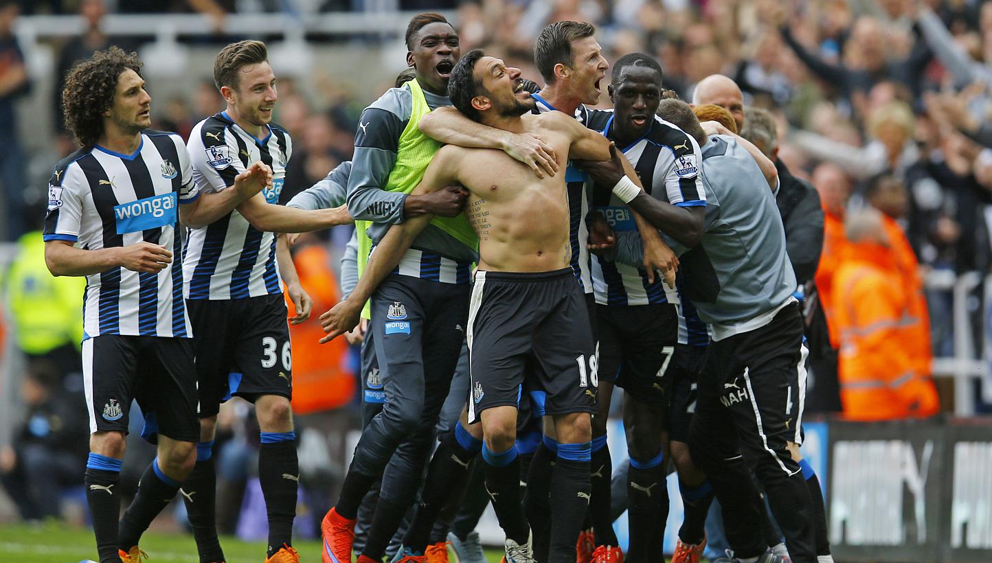 Jonas Gutierrez (centre, without shirt) celebrates with manager John Carver (right, in grey) and team mates after scoring the second goal for Newcastle United. -- PHOTO: REUTERS