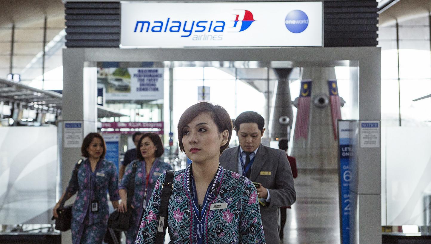 Malaysia Airlines air crew walking through Kuala Lumpur International Airport in Sepang, Malaysia, on Aug 26, 2014. -- PHOTO: BLOOMBERG