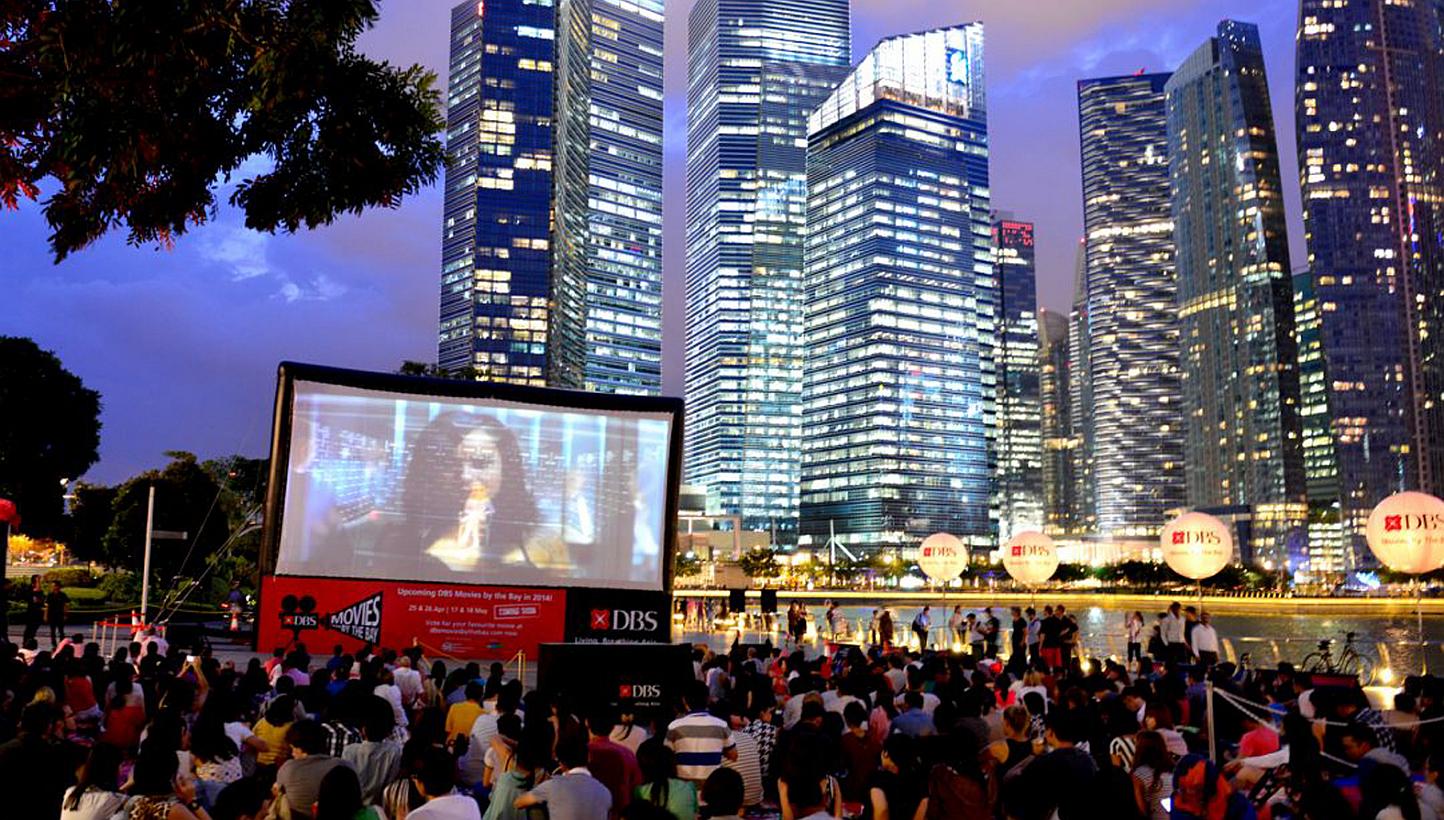 People watching a film during a screening at the DBS Movies by the Bay, a monthly event launched in October 2013. DBS has pledged to pump in another $12 million over the next three years to draw more people to the Marina Bay area, to make it a vibran