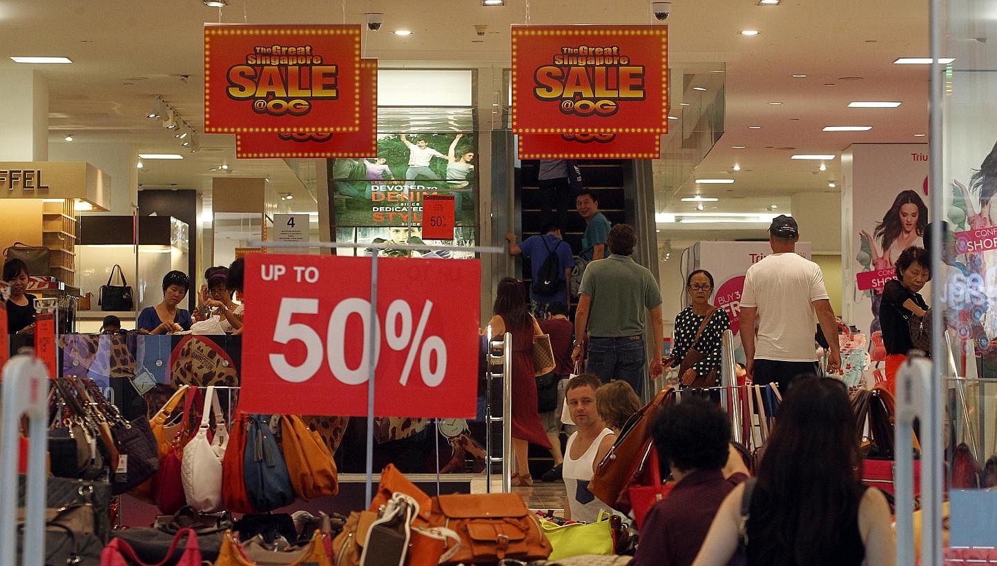 Signs showing discounts on May 30, 2014, the first day of the Great Singapore Sale (GSS) last year. The GSS will begin this Friday, but bargain-hunters can start early as several major high street retailers are already offering early sales. -- ST FIL