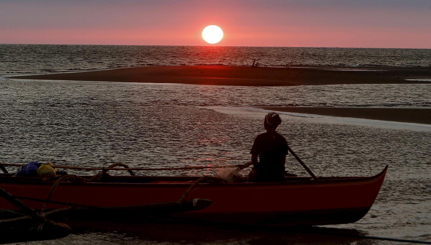 A fisherman watches the sunset in the South China Sea, about 130 nautical miles from Scarborough Shoal in the coastal town of Masinloc, Zambales in northern Philippines on April 21, 2015. -- PHOTO: REUTERS&nbsp;