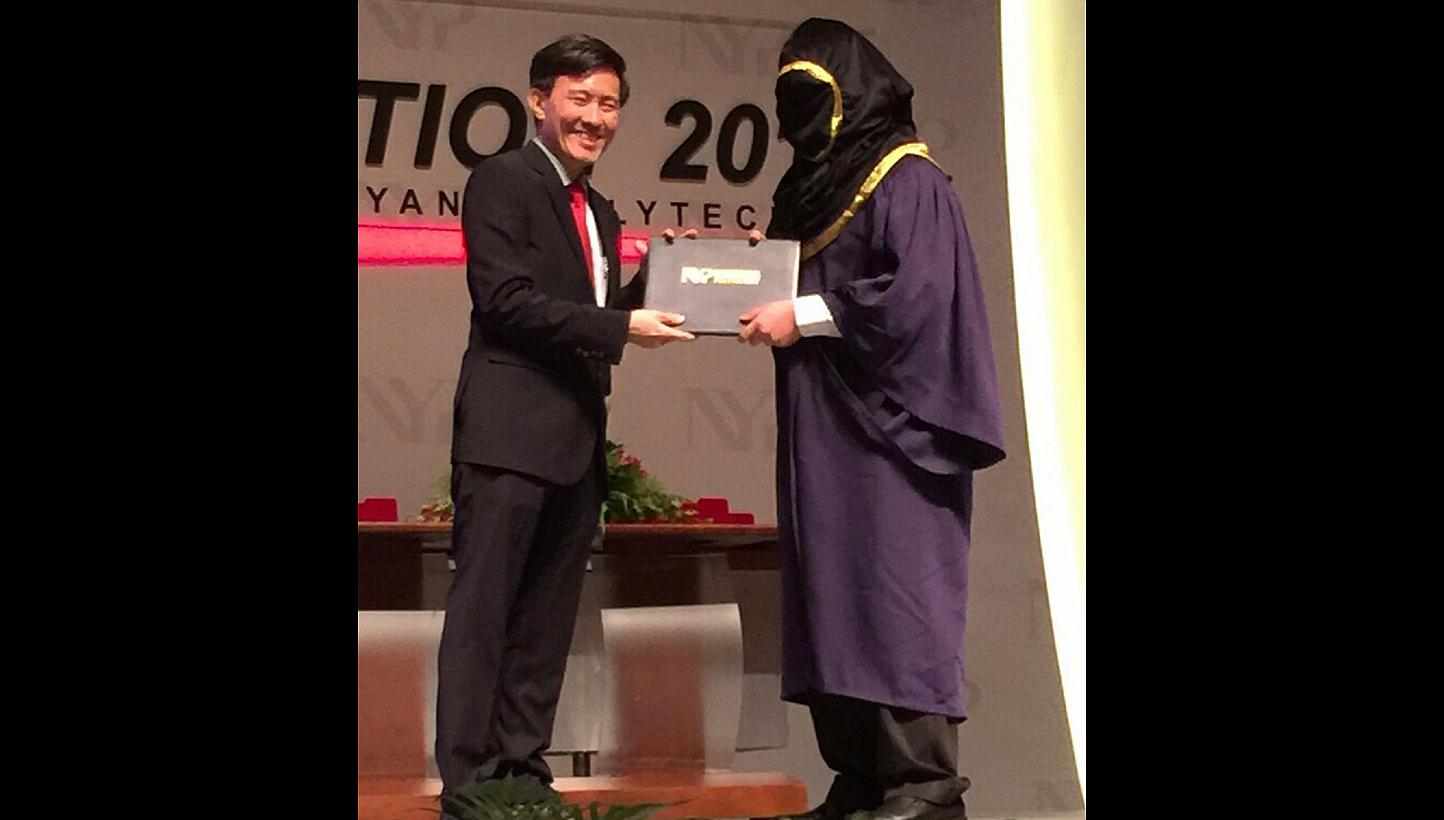 A student from Nanyang Polytechnic turned up for his convocation ceremony last week with a hood covering his entire face. -- PHOTO: SHIN MIN DAILY NEWS