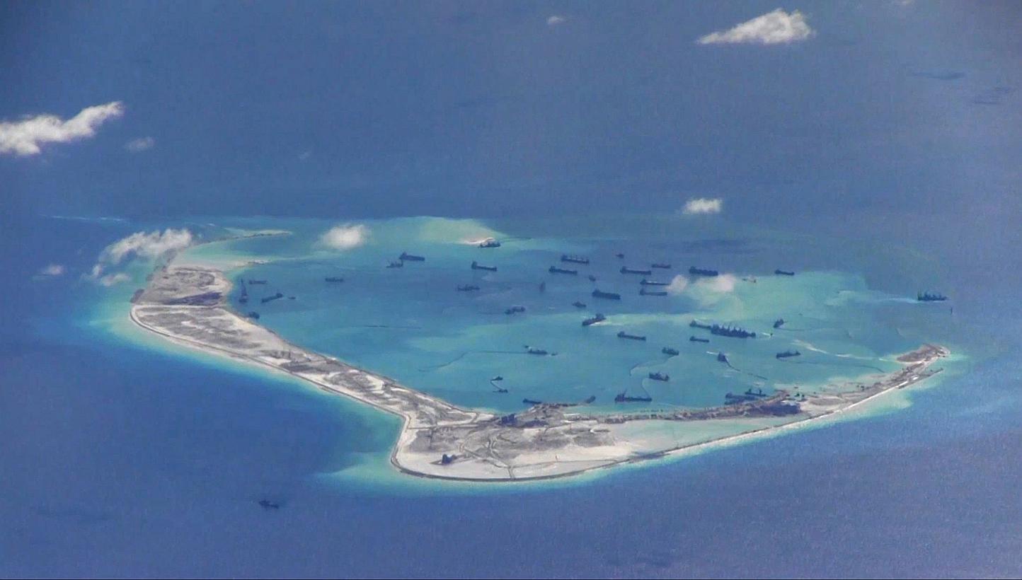 Chinese dredging vessels are purportedly seen in the waters around Mischief Reef in the disputed Spratly Islands in the South China Sea, in this file still image from video taken by a P-8A Poseidon surveillance aircraft and provided by the United Sta