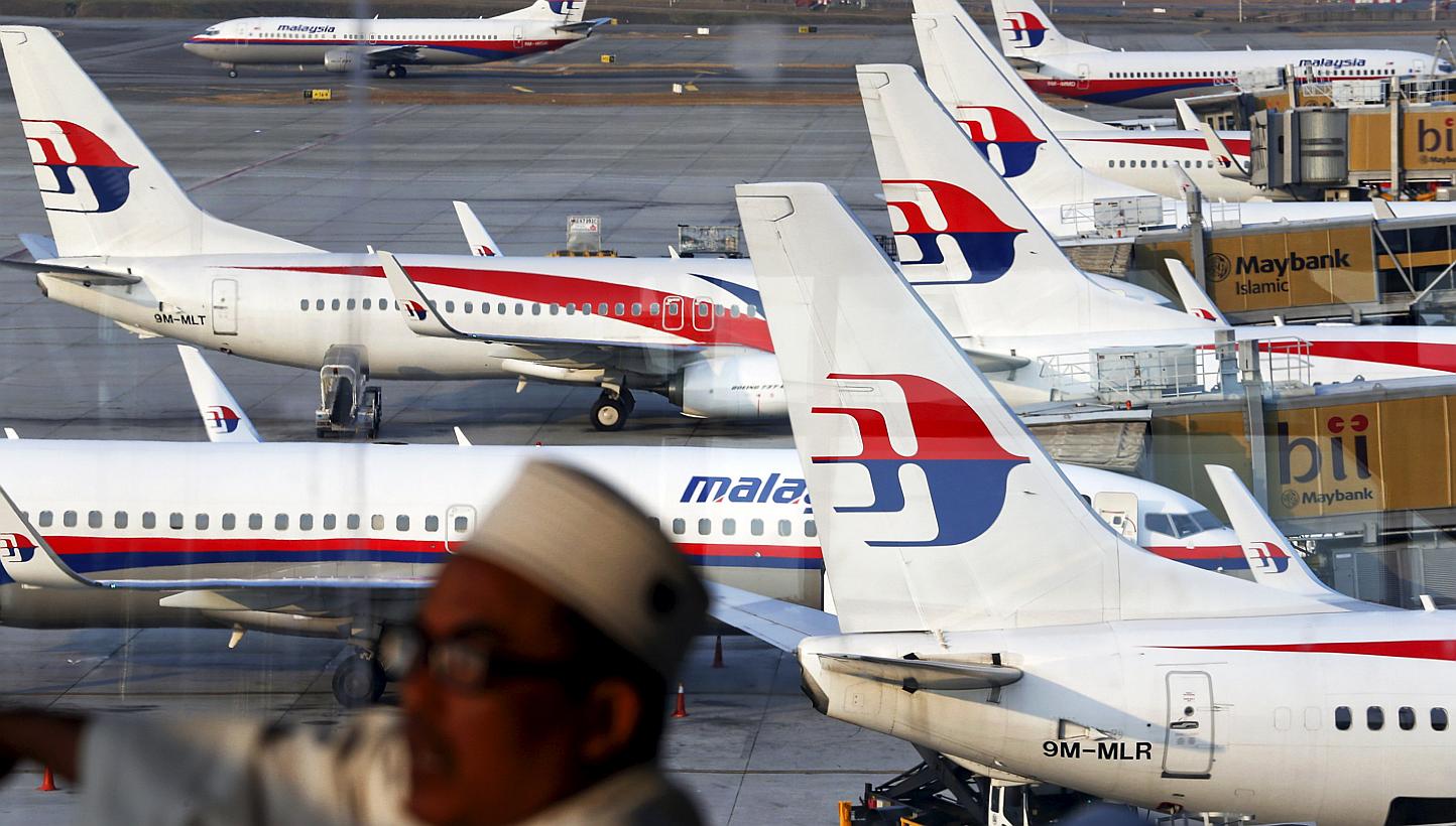 Malaysia Airlines planes are seen on the tarmac at the Kuala Lumpur International Airport in this March 12, 2014 file photograph. The loss-making airline is set to undergo a complete overhaul as it is restructured into a new company. -- PHOTO: REUTER