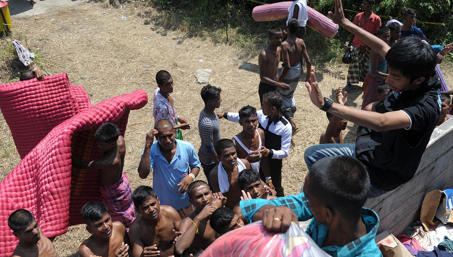 Bangladeshi migrants receiving mats at a shelter at Langsa in Indonesia's Aceh province on May 24, 2015.
